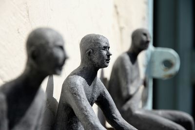 Statues by wall