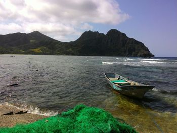 Scenic view of sea and mountains against sky