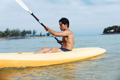 Man kayaking in lake