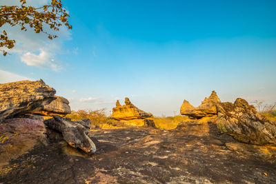 Rock formations on landscape against sky