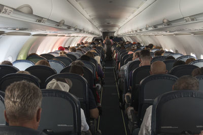 Rear view of people sitting in airplane