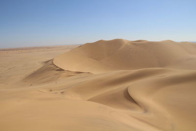 Scenic view of desert against clear sky