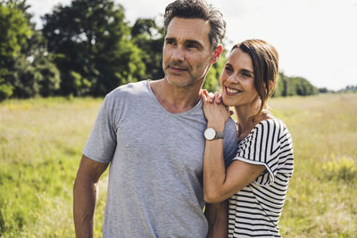 Portrait of friends standing on field