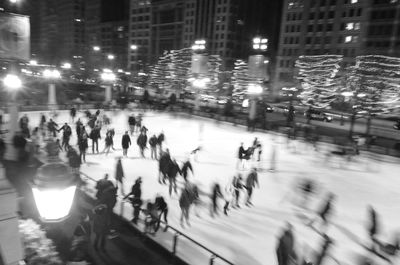 Blurred motion of people in city at night