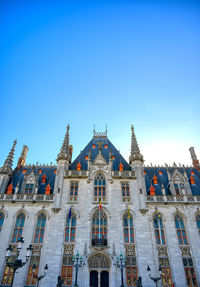 Low angle view of building against blue sky