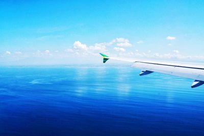 Cropped image of airplane flying over clouds