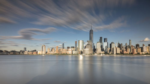 Modern buildings in city against cloudy sky