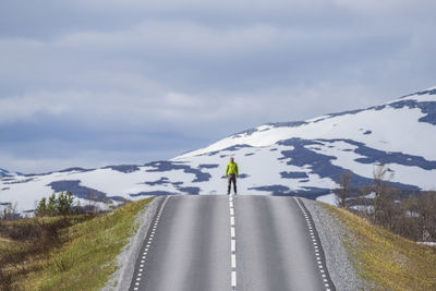 Man standing on road against sky