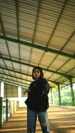 Portrait of woman standing against ceiling