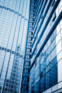 Low angle view of modern glass building in city