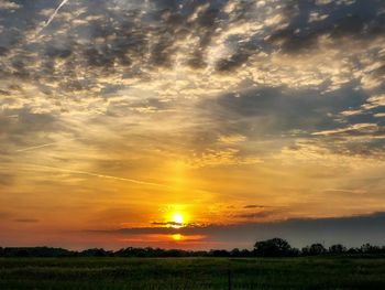 Scenic view of field against sky during sunset