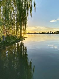 Scenic view of lake against sky at sunset