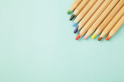 High angle view of colored pencils against white background