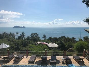 Scenic view of swimming pool by sea against sky