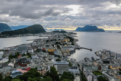 High angle view of city by sea against sky