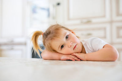 Portrait of cute baby lying on sofa at home