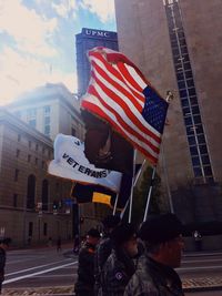 Woman with umbrella flag on the road
