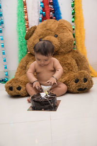 Full length of cute baby girl sitting on floor at home