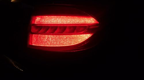 Close-up of illuminated light bulb in the dark