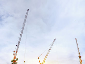 Low angle view of crane against sky