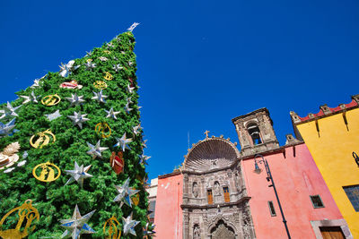 Low angle view of traditional building against clear blue sky