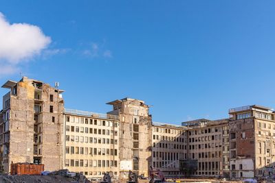 Low angle view of buildings against blue sky