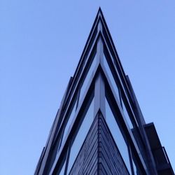 Low angle view of buildings against clear blue sky