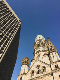 Low angle view of building against blue sky, urban building against historical
