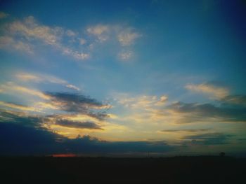 Silhouette landscape against scenic sky