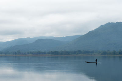 Scenic view of lake against cloudy sky