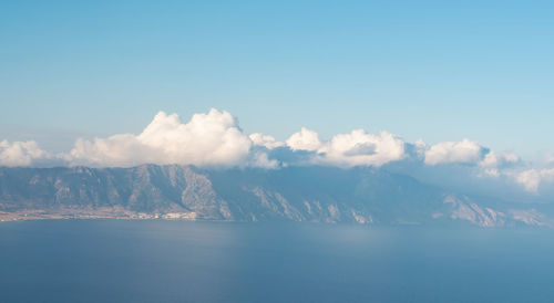 Scenic view of sea and mountains against sky