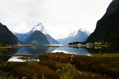 Scenic view of lake and mountains against sky