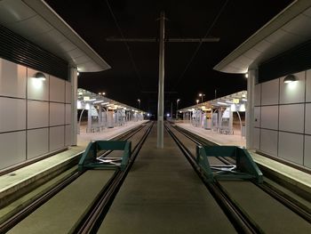 Illuminated railroad station platform at airport