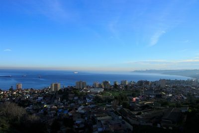 High angle view of city against blue sky