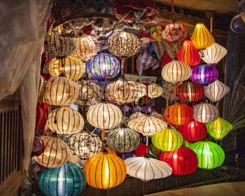 Low angle view of illuminated lanterns hanging on ceiling