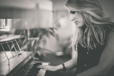 Woman playing piano at home