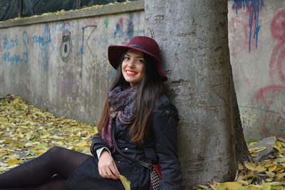 Portrait of smiling young woman sitting outdoors