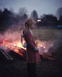 Girl standing outdoors at night