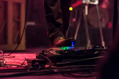 Low section of person with arms outstretched at home