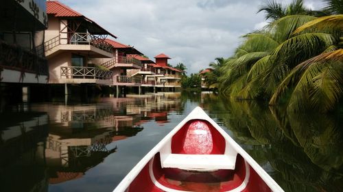 Boats in canal along buildings