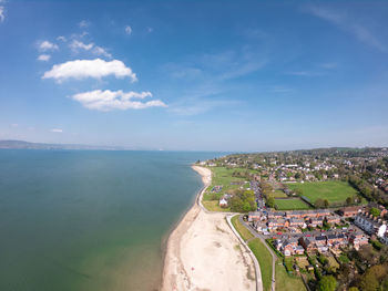 High angle view of townscape by sea against sky