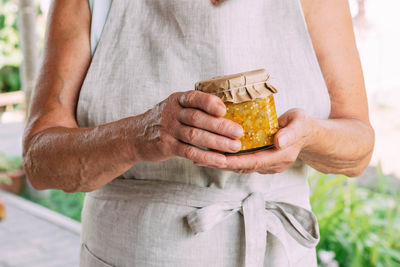 Midsection of man holding food