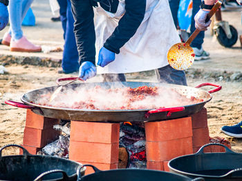 People preparing food at market stall