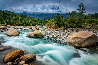 Scenic view of rocks in water against sky