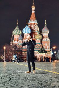 Full length of man in temple against sky at night