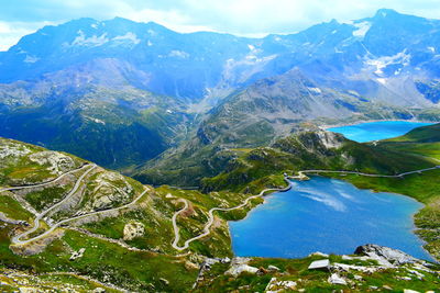 High angle view of lake amidst mountains against sky