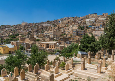 Buildings in city against clear sky