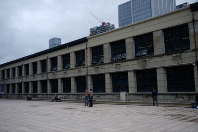 Men in city against sky