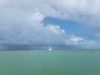 Sailboat in sea against sky