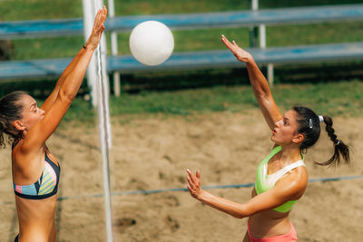 Beach volleyball female player on the net